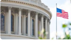 The capital of the USA building with flying American Flag.